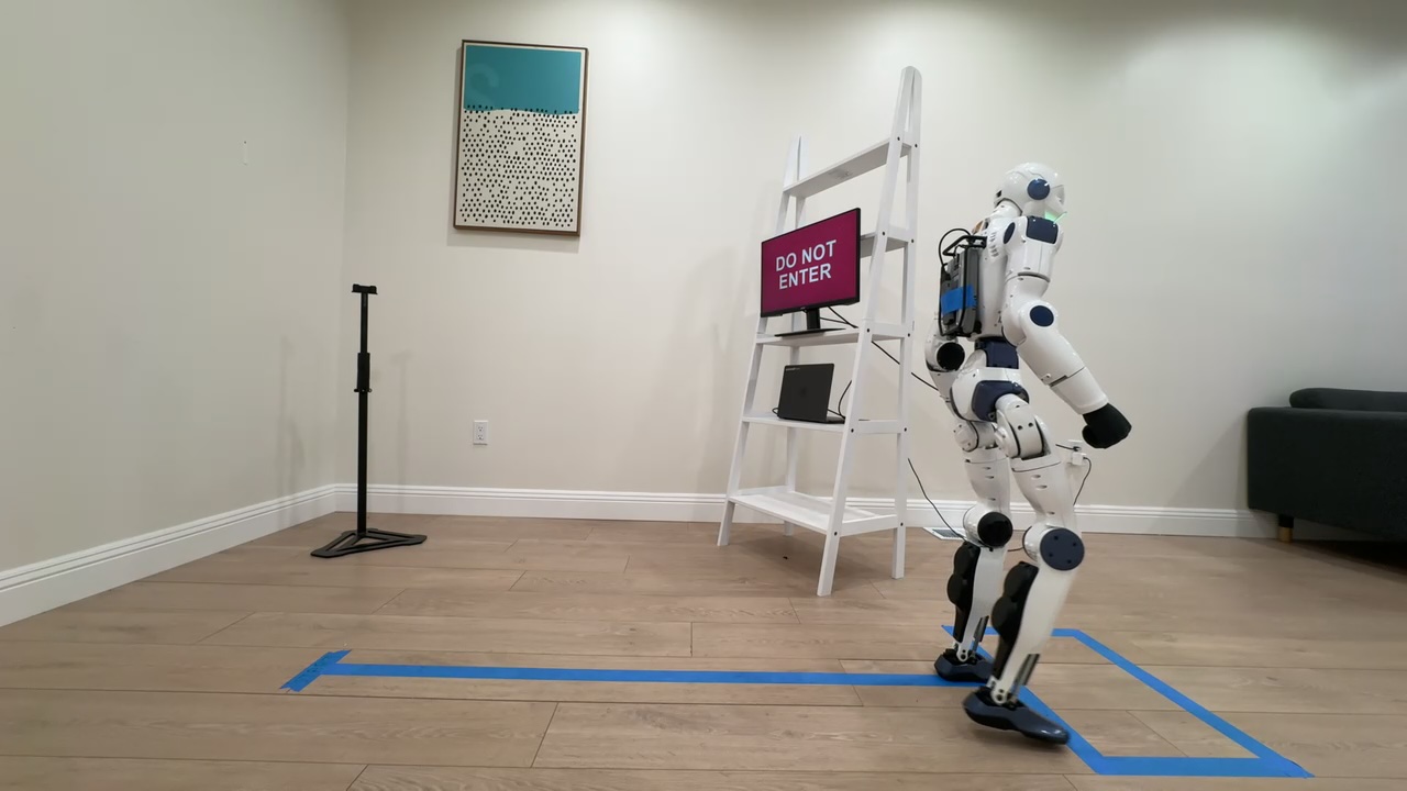 A Unitree R1 humanoid at the blue goal box beside a DO NOT ENTER sign during a Coop benchmark trial.